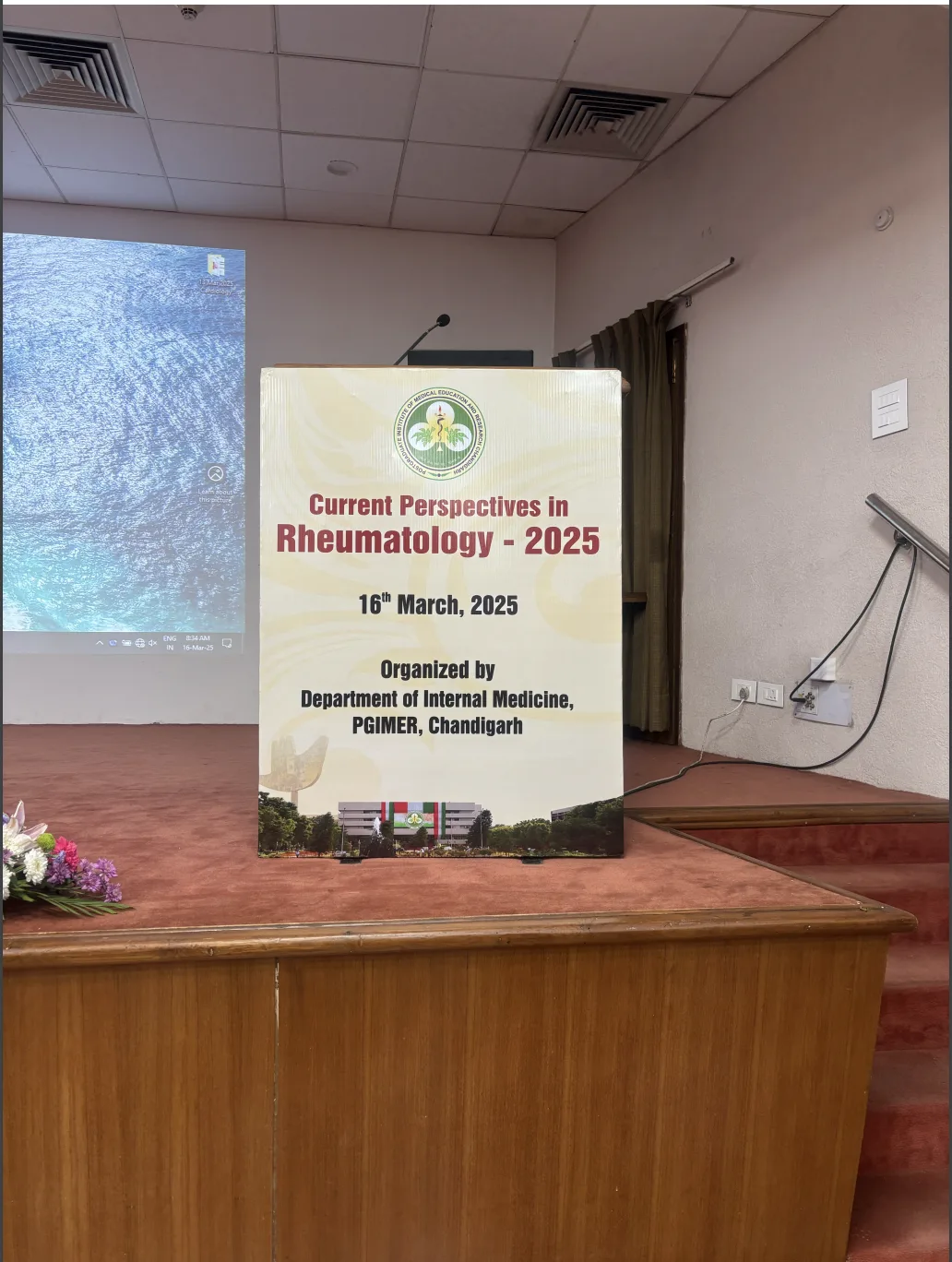 Current Perspectives in Rheumatology 2025 — podium with event banner, PGIMER Chandigarh