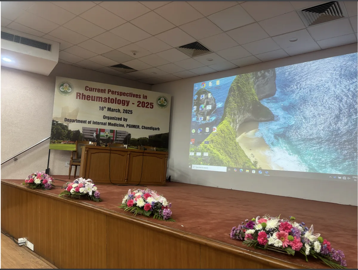 Current Perspectives in Rheumatology 2025 — stage with floral decoration and event banner