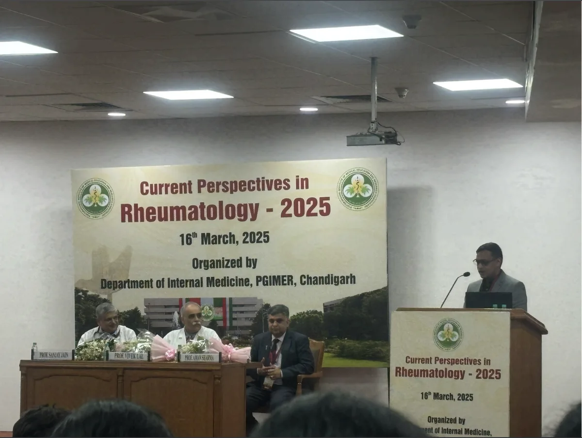 Current Perspectives in Rheumatology 2025 — panel on stage with event banner